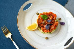Salmon tartare with chopped avocado on plate